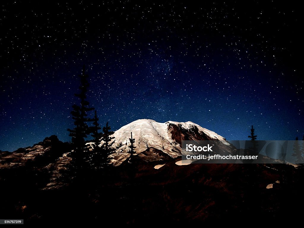 Mt. Rainier at Night Mt. Rainier lit up by the moon at night time (with a hint of the milky way). Beauty In Nature Stock Photo