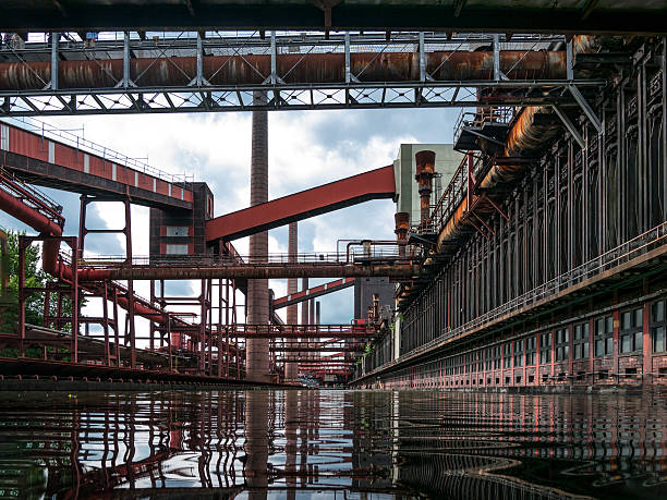 Zollverein Coking PLant water reflections Transport bands of the coking plant reflected in the water basin preserved by the red lead paint against the time and oxidation  essen germany stock pictures, royalty-free photos & images