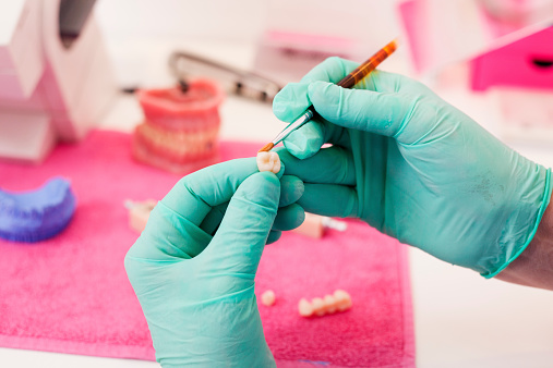 Dental technician working on a tooth crown