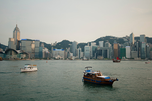 Hong Kong, China - June 20th, 2013: Star ferry crossing the Victoria Harbor with a view of Hong Kong Island skyline in the background.