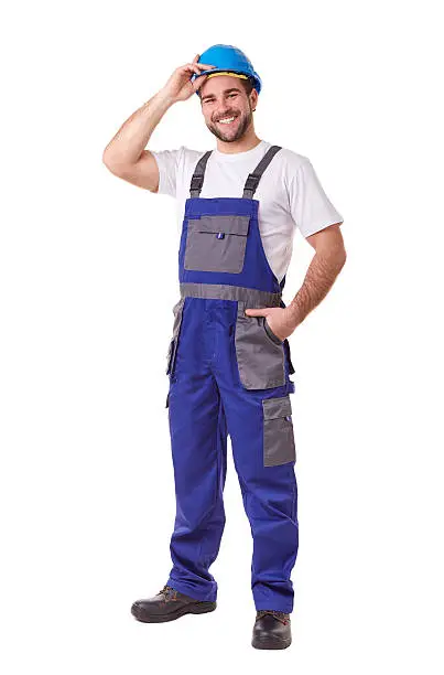 Full length portrait of a manual worker with blue helmet and uniform