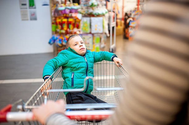 istock Parent Pushing Son in Shopping Trolley 514772246