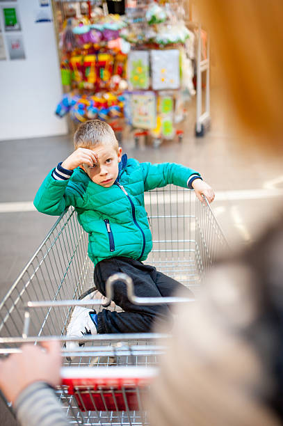 istock Mother Pushing Son in Shopping Trolley 514772344