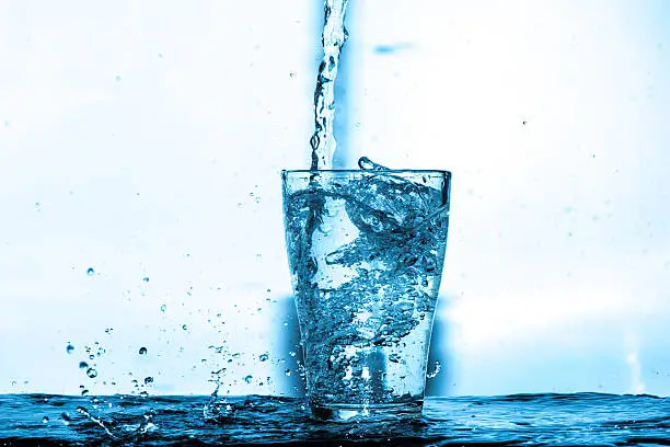 Photo of water splash in a glass