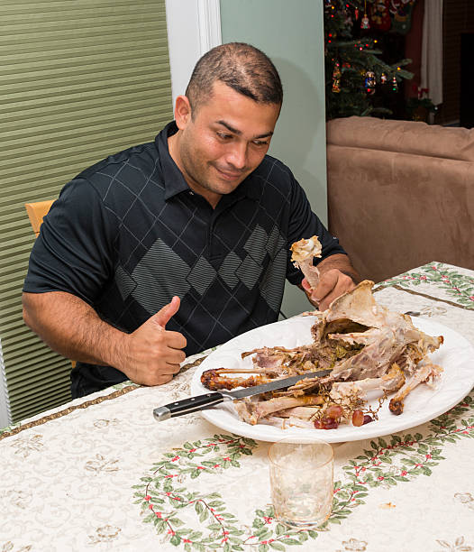 istock Man can't believe he ate a whole turkey 514773011
