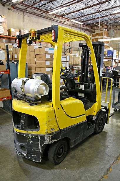 Propane Forklift Propane powered forklift in warehouse propane photos stock pictures, royalty-free photos & images