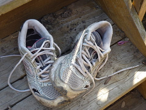 old running shoes, one atop the other