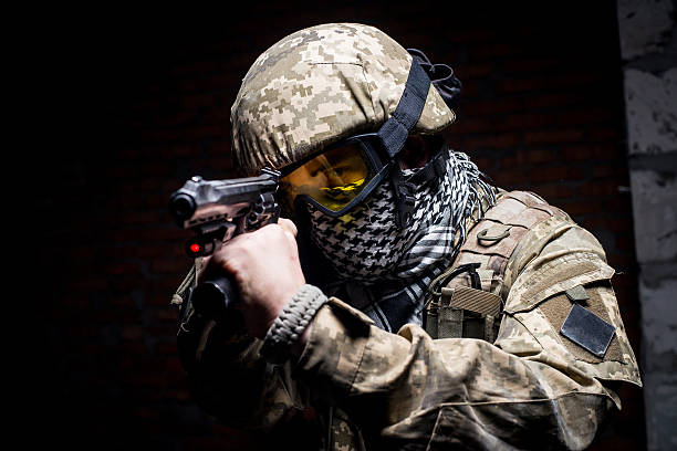 istock Man in military uniform with gun in his hand 514774966