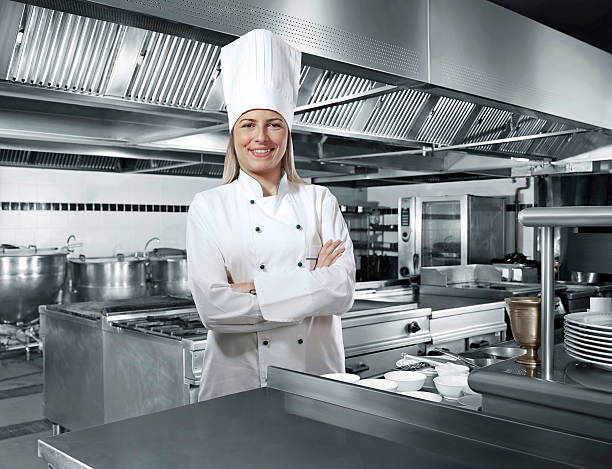 woman chef Woman chef inside a commercial kitchen chefs whites stock pictures, royalty-free photos & images