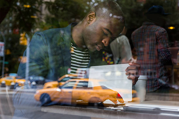 istock Young Black Man with Digital Tablet in a Cafe 514776427