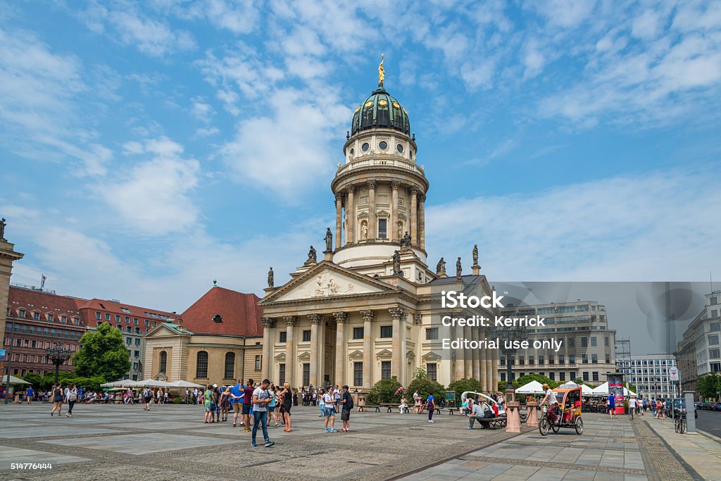 French Cathedral at Gendarmenmarkt in Berlin, Germany Berlin, Germany - June 13, 2015: French Cathedral at Gendarmenmarkt in Berlin, Germany. Tourists walking around, taking photos or driving with pedicab.   Architectural Column Stock Photo