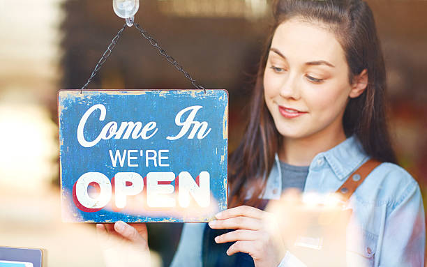 istock Beautiful florist turning open sign at shop window 514778518