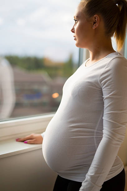 istock Thoughtful pregnant woman looking out the window 514781230