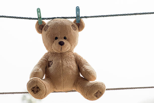 istock Teddy bear was tucked on a clothes line . 514781946