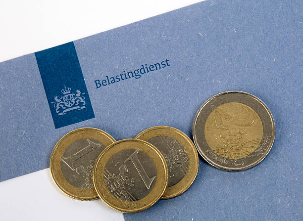 dutch blue tax envelope of the tax office  euro coins the hague, Netherlands-march 11, 2016: dutch blue tax envelope of the tax office with euro coins travel refund stock pictures, royalty-free photos & images