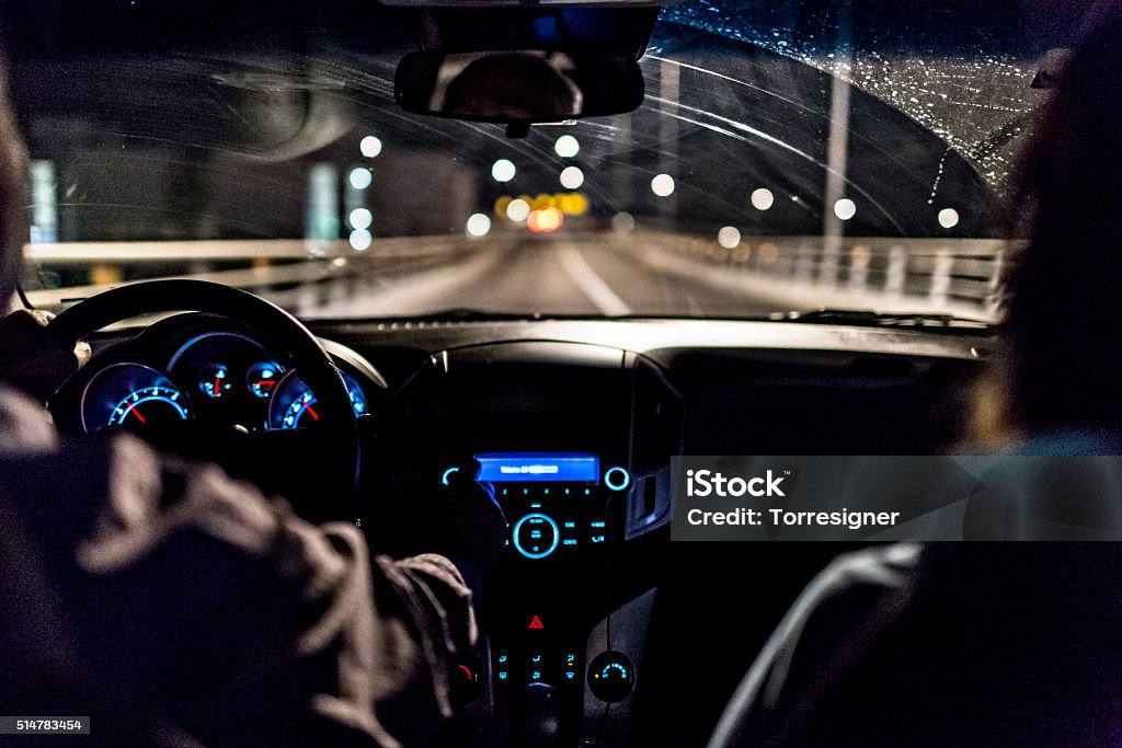 Driving A Car In Night Driving a car in night city scenery. Night Stock Photo