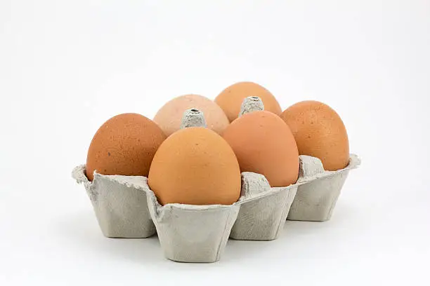 Six hen eggs, isolated in a white background