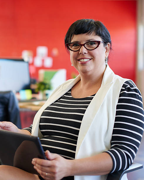 istock Confident female designer working on a digital tablet in red 514786916