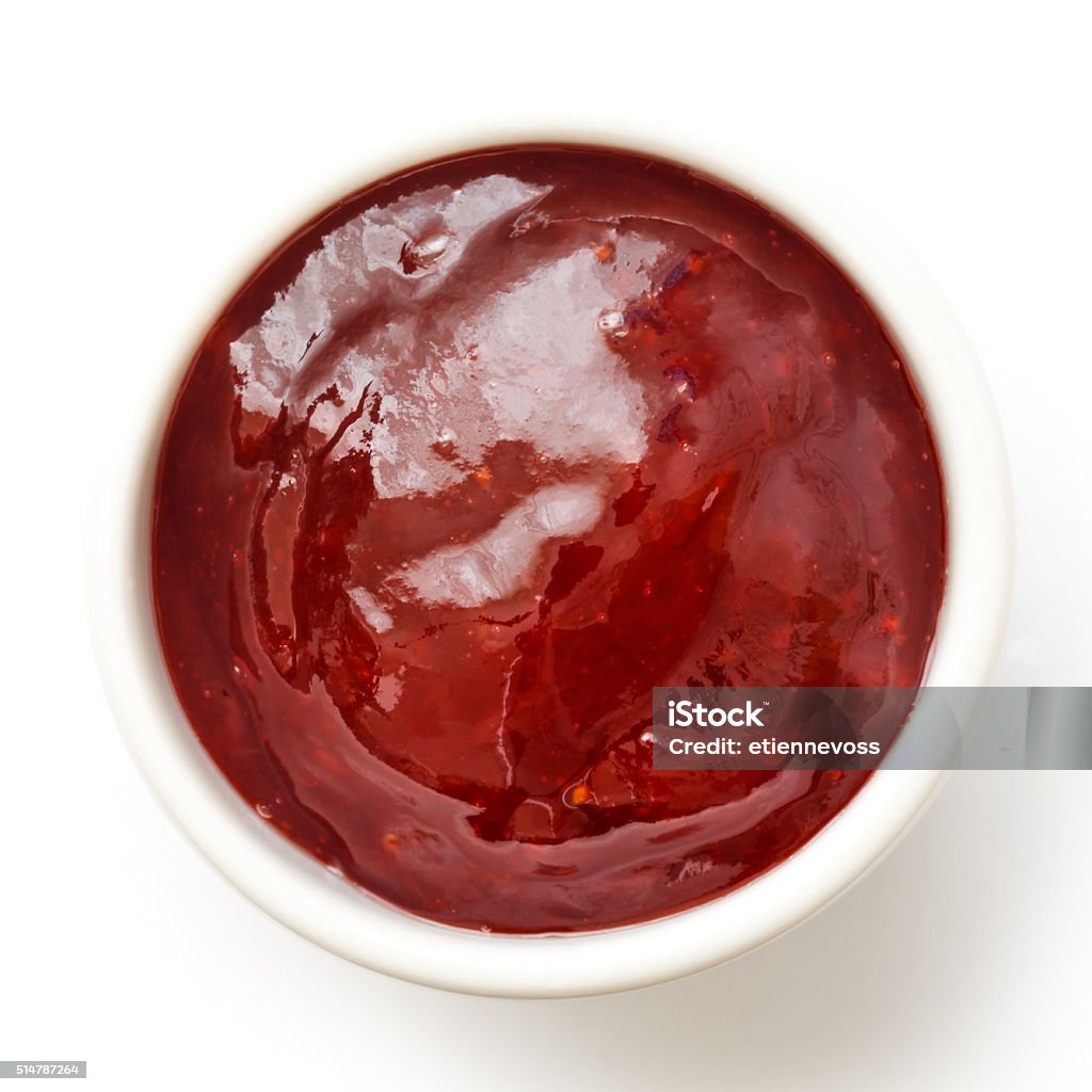 Ramekin of fruit jam. Ramekin of red strawberry jam isolated on white. From above. Preserves Stock Photo