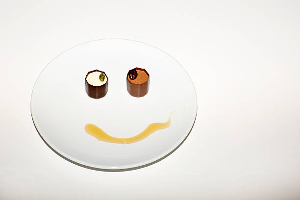 The dessert, chocolate and honey. Smiley with candy and honey on the plate. 