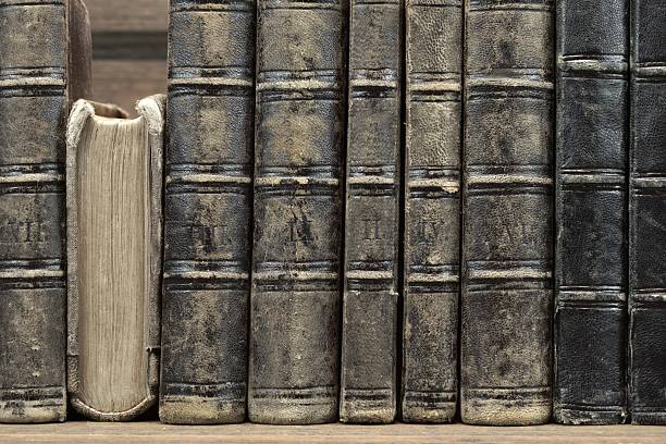 istock Old Shabby Books With Black Leather Cover Horizontal Background 514790530