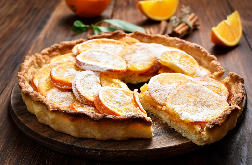 Sweet orange pie on wooden table