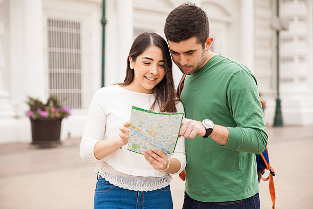 istock Couple of tourists looking at a map 514794442