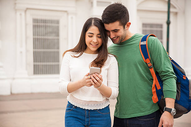 istock Cute young couple looking at a smartphone 514794612
