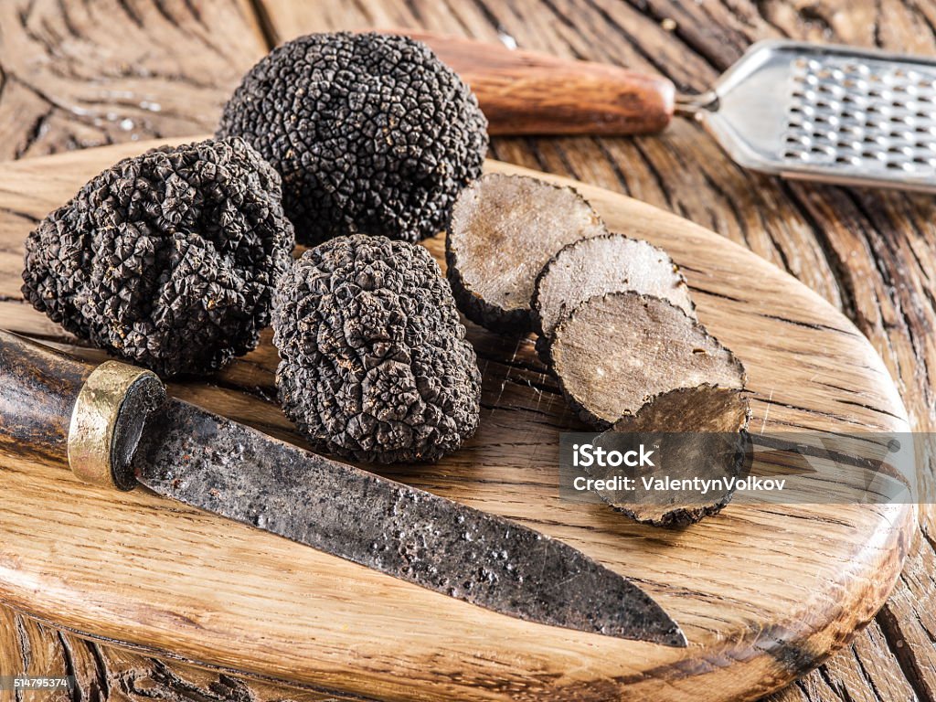 Black truffles. Black truffles on the old wooden table. Black Color Stock Photo