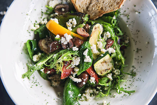 Grilled Veggy Salad Top view of rocket salad with grilled vegetables and feta cheese mediterranean food photos stock pictures, royalty-free photos & images