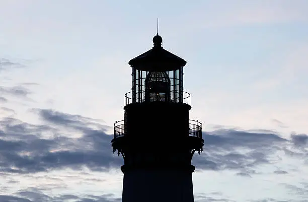 Photo of Yaquina Bay Lighthouse Silhouette Against Cloudy Sky