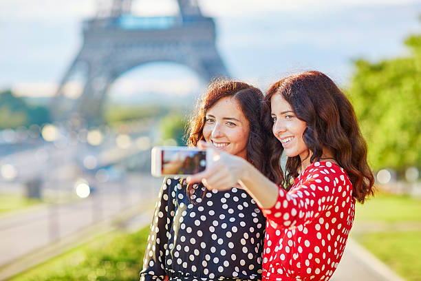 istock Beautiful twin sisters taking selfie in front of Eiffel Tower 514796050