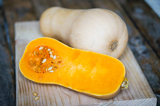 istock Uncooked sliced butternut squash on wooden background 514796096