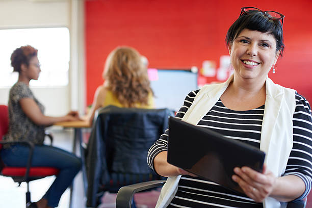 istock Confident female designer working on a digital tablet in red 514796782
