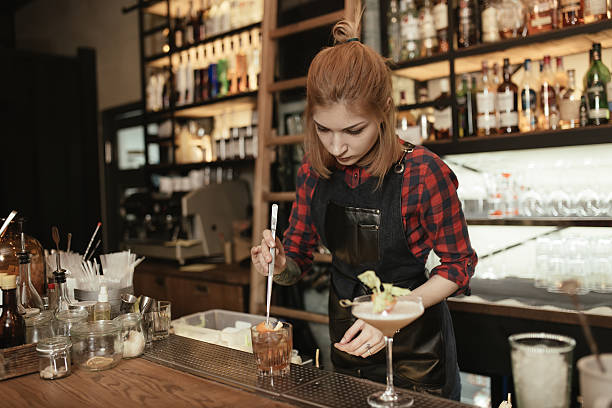 istock Woman bartender making an alcohol cocktail at the bar 514797280