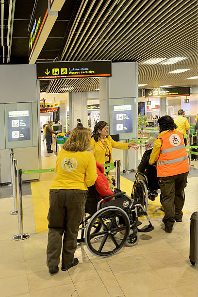 Disabled passengers at airport Madrid, Spain - February 24, 2016:  airport porter stock pictures, royalty-free photos & images