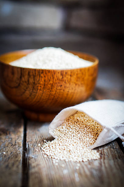 istock White quinoa on rustic wooden background 514798386