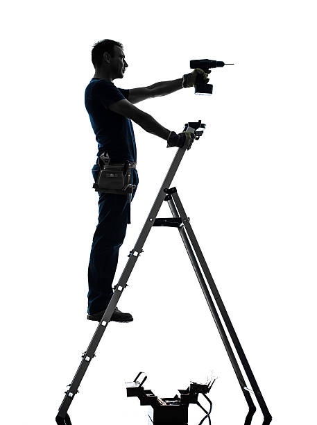 istock manual worker man on stepladder drilling silhouette 514799317