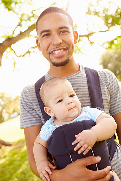 istock Father With Son In Baby Carrier Walking Through Park 514800333