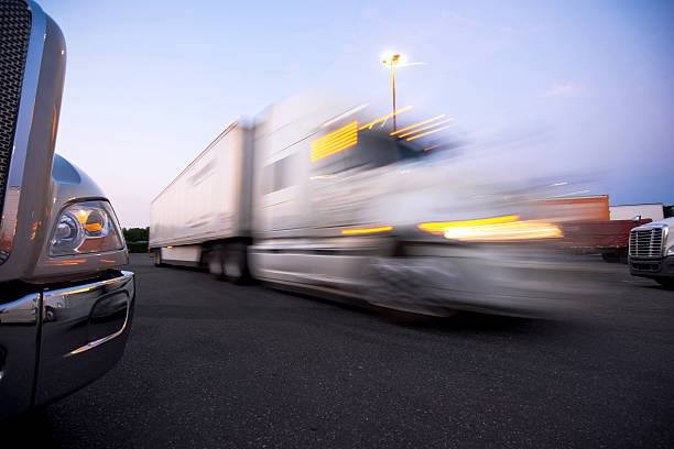 istock Fragment modern trucks on trakstope against moving truck with headlights 514801381
