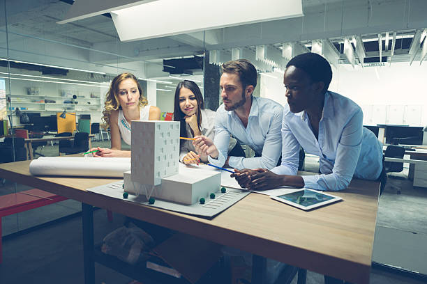 istock Multiethnic Team of architects reviewing architectural model in the office. 514801639