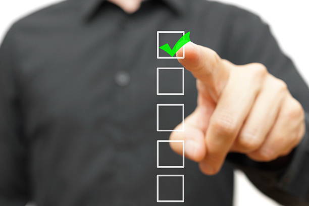 istock Young businessman checking mark on checklist with marker. 514803247