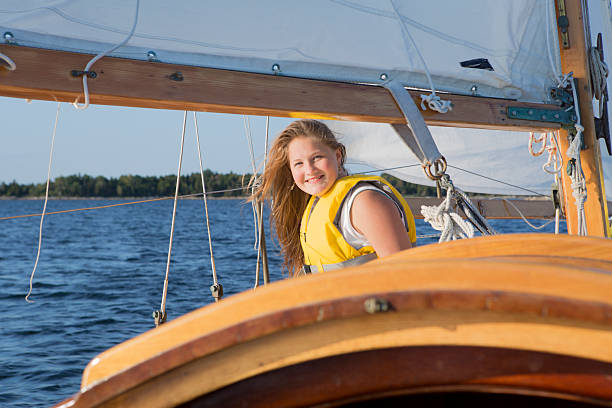 istock Cute girl sailing on a sailboat 514803655