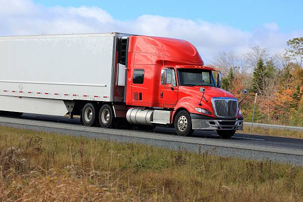 istock Semi truck on a highway, trees in background 514827954