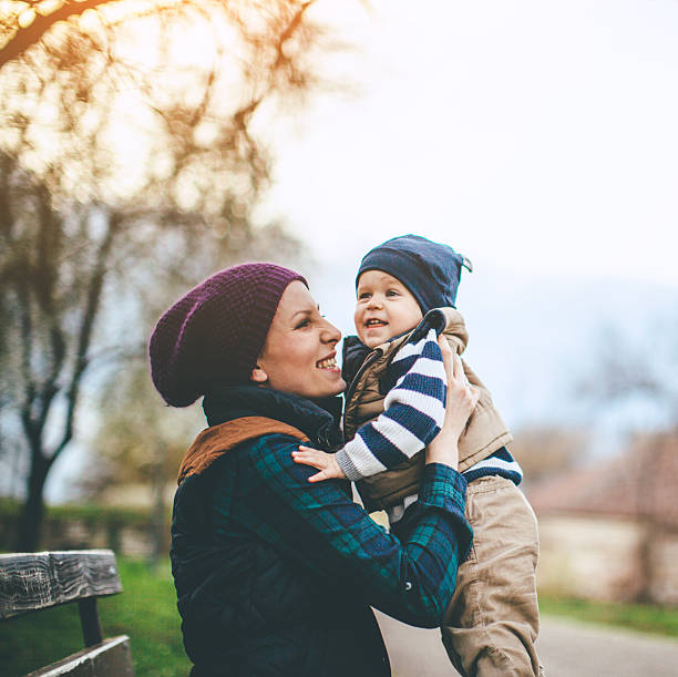 istock mother and son playing outdoors 514828320