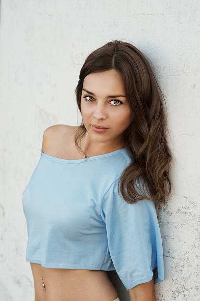 istock beautiful sexy woman at white wall 514828373