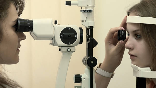 istock Young woman having her eyesight examined 514829195
