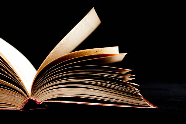 istock Old book on black color background 514829731