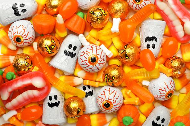Halloween candy background Halloween background of mixed candies, orange color theme jellybean photos stock pictures, royalty-free photos & images