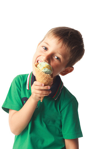 Little boy eating ice cream isolated on white background